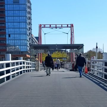 Bridge at Kiel's main station connecting Kiel's east and west side. Some people crossing the bridge can be seen.