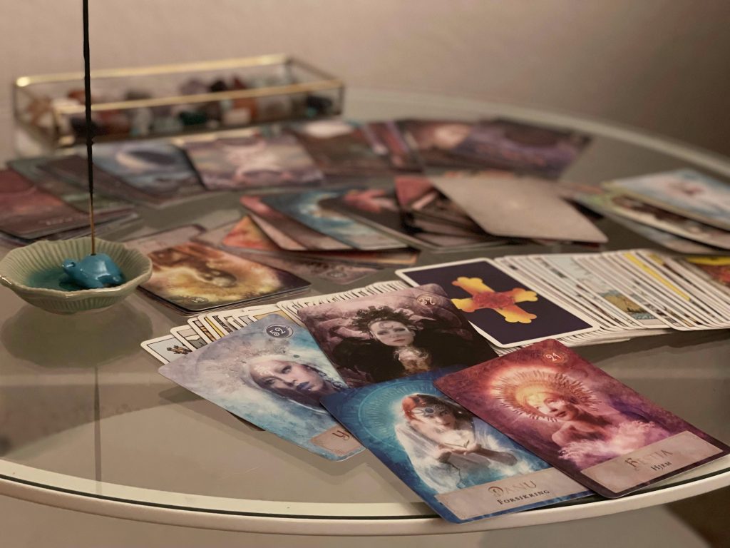 Glass table with several tarot cards laying on top